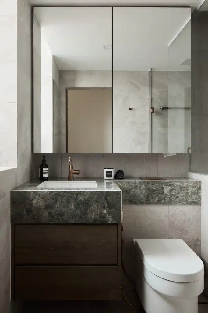 Warm modern contemporary bathroom with emerald table top