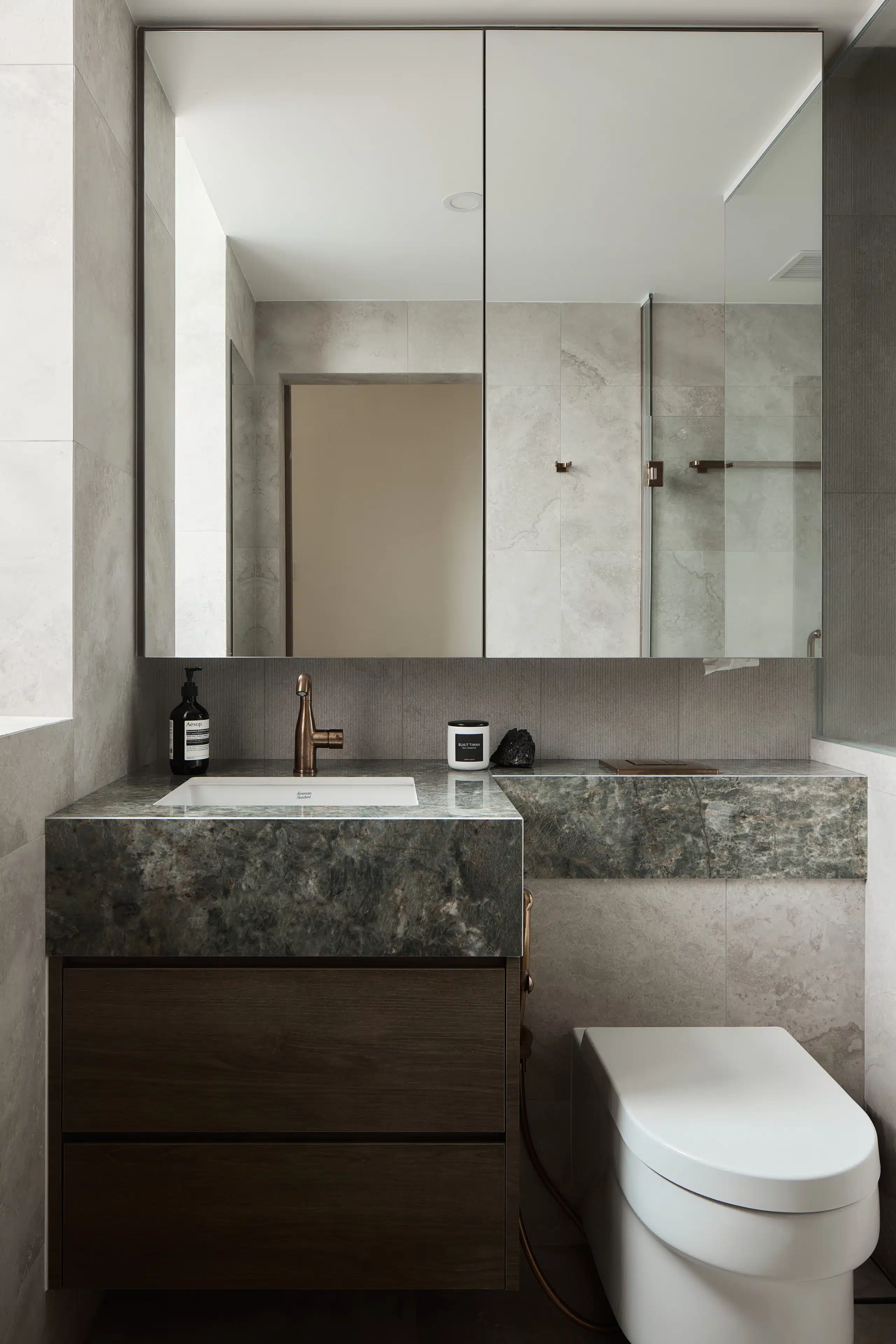 Warm modern contemporary bathroom with emerald table top